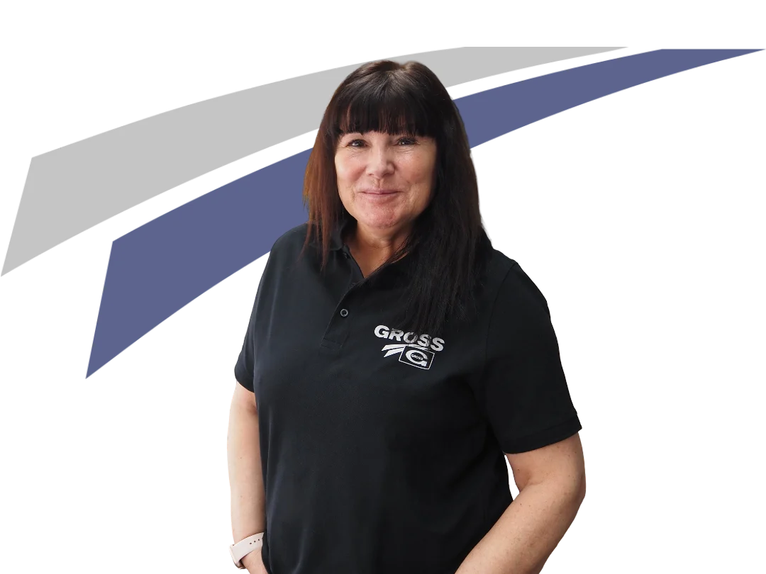 Frau mit langen, dunklen Haaren trägt ein schwarzes Polo-Shirt mit dem Logo GROSS und steht vor einem grafischen Hintergrund.